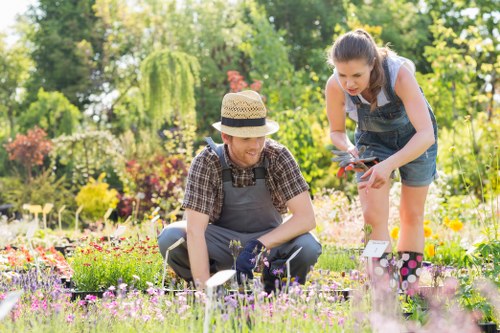 Gardeners arranging recycling bins in Kenton garden